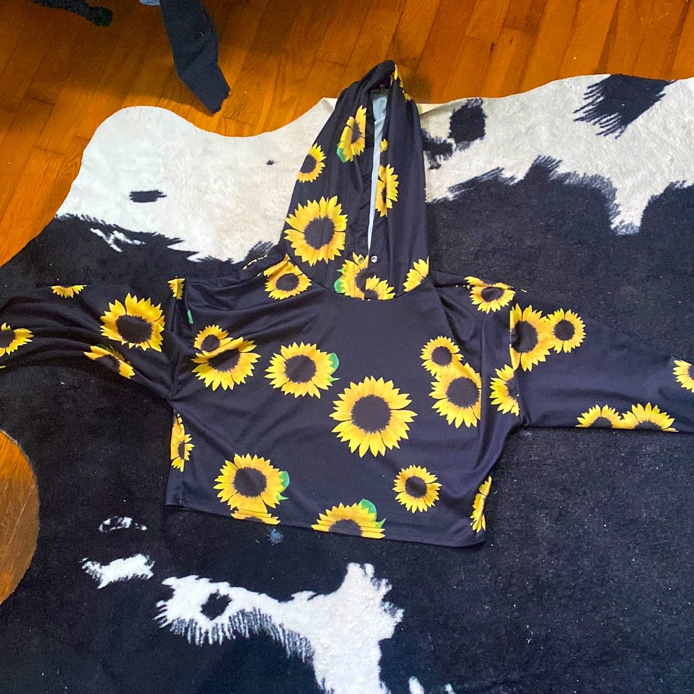 A black and yellow cropped hoodie with sunflowers